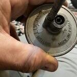 You can see the remains of the spring inside the v